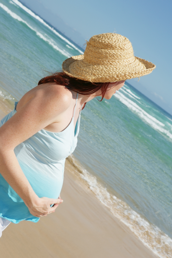 young pregnant woman by the ocean